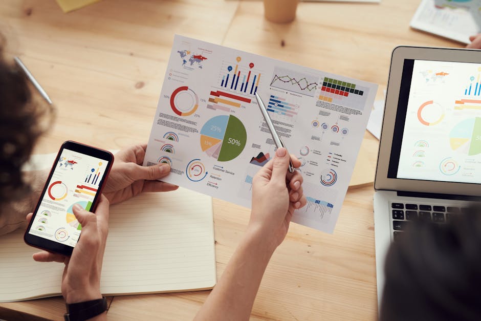 pexels-photo-3183153-3183153 Team members analyze charts during a business meeting with laptops and smartphones.