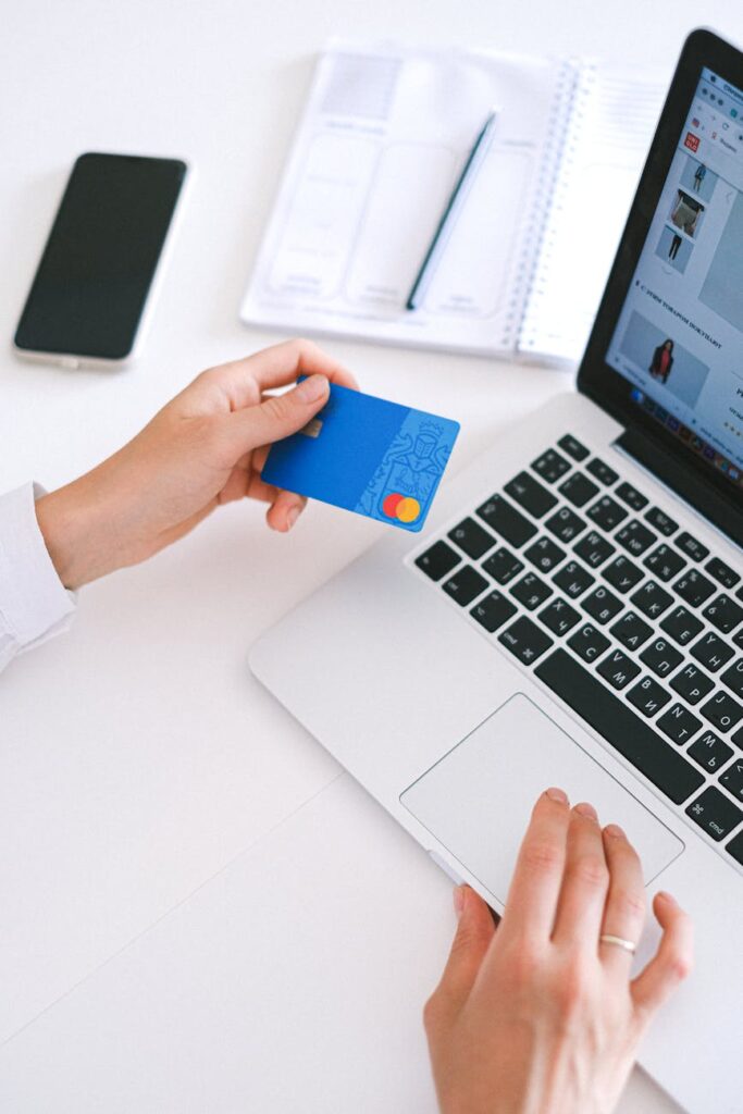 pexels-photo-4482900-4482900 Person making an online purchase with a credit card on a laptop, showcasing modern ecommerce technology.